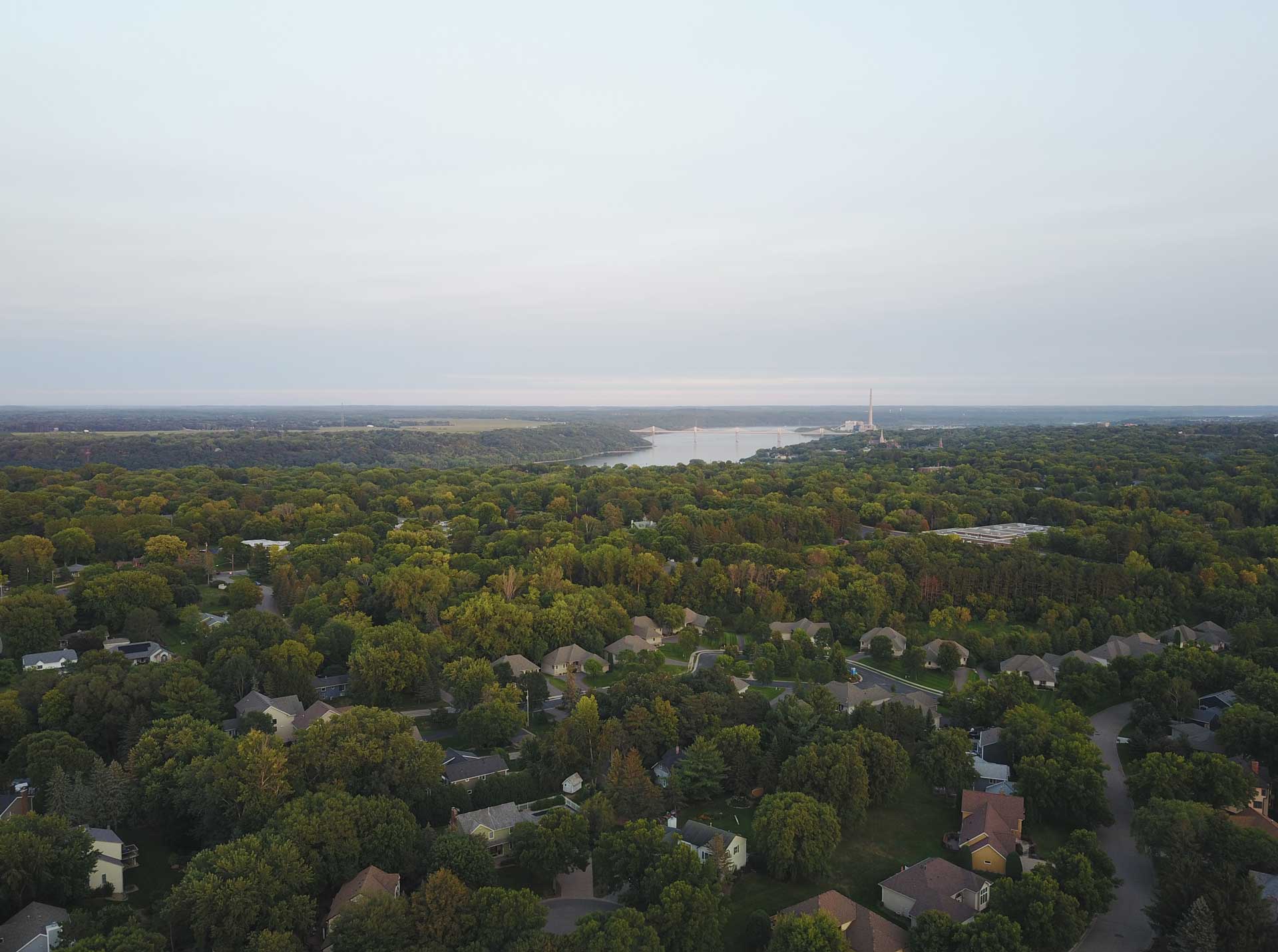 First-time homebuyer exploring a property with realtor Daniel Graves in Stillwater, Minnesota - Aerial Above Oak Glen, Shot towards St Croix River Downtown